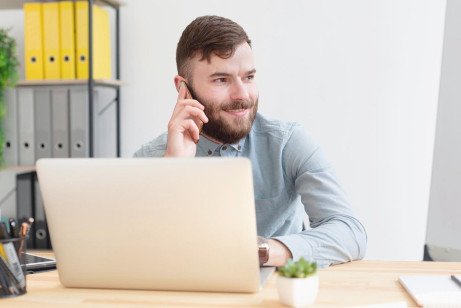 Gaming studio environment showing developers at workstations with multiple monitors displaying various game projects in development